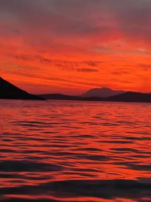 a sunset over a large body of water at Ariadne in Halki
