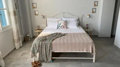 a bedroom with a bed with a metal headboard at Ariadne in Halki