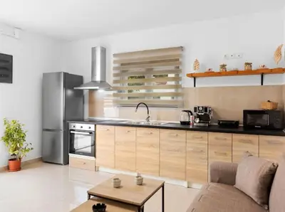 a kitchen with a couch and a table in a room at VaStekaHouse in Haraki