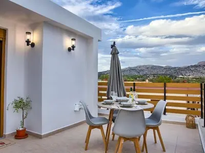 a patio with a table and chairs and an umbrella at VaStekaHouse in Haraki