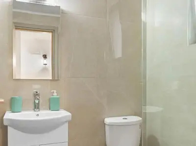a bathroom with a toilet and a sink and a mirror at VaStekaHouse in Haraki