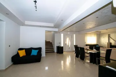 a living room with a couch and a table with chairs at Calm and Joy Summer House in Afantou