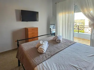 a bedroom with a bed with towels on it at Calm and Joy Summer House in Afantou