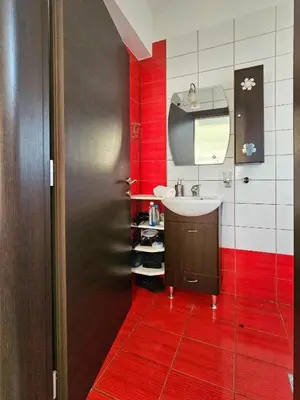 a bathroom with a sink and a red wall at Calm and Joy Summer House in Afantou