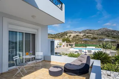 a house with a balcony with a view of the beach at Calm and Joy Summer House in Afantou