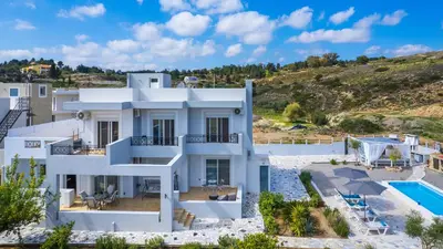 a large white house with a swimming pool at Calm and Joy Summer House in Afantou