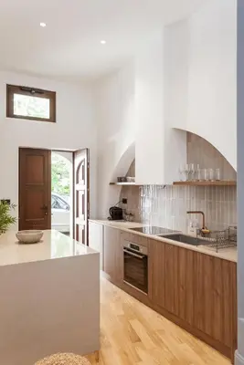 a kitchen with wooden cabinets and a counter top at Zerania Suites in Rhodes Town