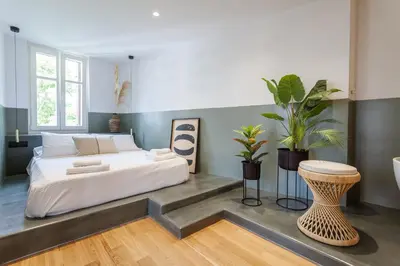 a bedroom with a bed and a table and plants at Zerania Suites in Rhodes Town