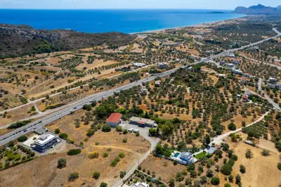 an aerial view of a house and road next to the ocean at Villa Costazia in Kalithies