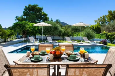 a table with fruit on it next to a pool at Villa Costazia in Kalithies