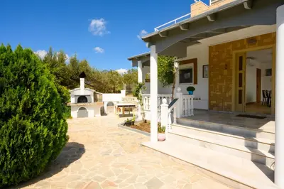 a house with a patio and a porch at Villa Costazia in Kalithies