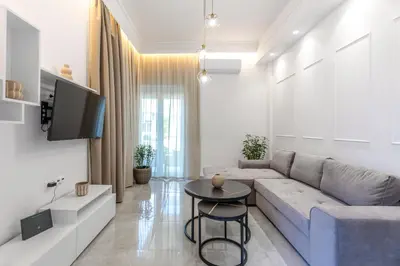a living room with a couch and a tv at Micasa Suite Rhodos in Rhodes Town
