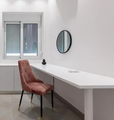 a white desk with a chair and a mirror at Micasa Suite Rhodos in Rhodes Town