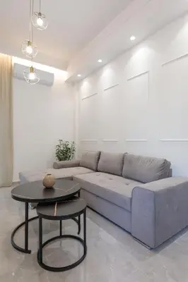 a living room with a couch and a table at Micasa Suite Rhodos in Rhodes Town