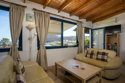 a living room with a couch and a table at Villa Pebble in Pefki Rhodes