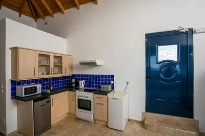 a kitchen with a blue door in a room at Villa Pebble in Pefki Rhodes