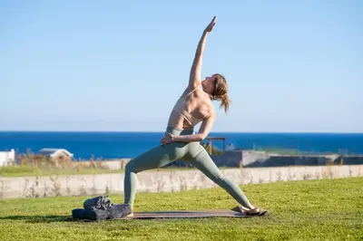 a woman doing a yoga pose on the grass at Elixir Vacation Houses in Gennadi