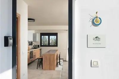 a kitchen and dining room with a door leading into a house at Elixir Vacation Houses in Gennadi