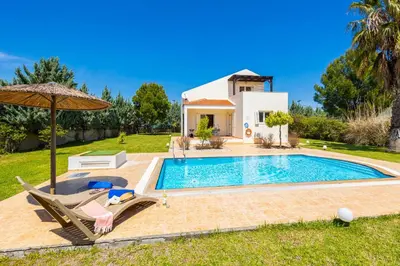 a villa with a swimming pool and a house at Villa Athena Classico in Kolimbia