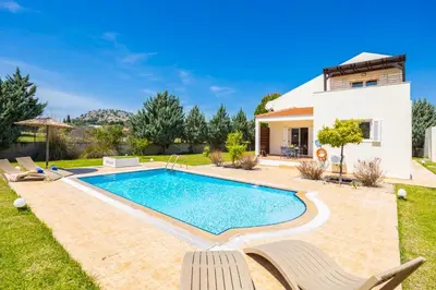 a swimming pool in the backyard of a villa at Villa Athena Classico in Kolimbia
