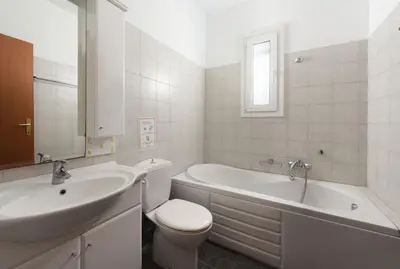 a bathroom with a sink and a tub and a toilet at Villa Apollo Classico in Kolimbia