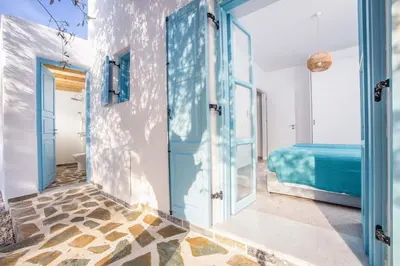 a room with a blue door and a bed at Villa Kalathos Dream Galazio in Kalathos
