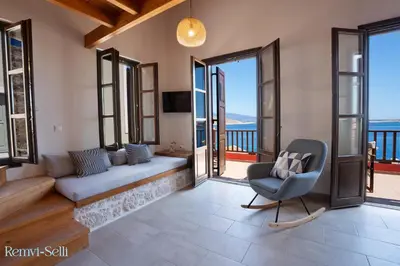 a living room with a couch and a chair at Remvi Seaside Houses in Halki