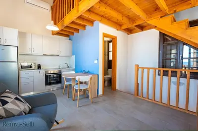 a kitchen and dining room with a table and chairs at Remvi Seaside Houses in Halki