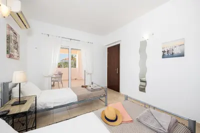 a bedroom with a bed and a desk in a room at Villa Maia in Phanaes