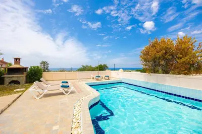 a swimming pool with two lounge chairs and a swimming pool at Villa Maia in Phanaes