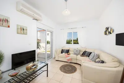 a living room with a couch and a fireplace at Villa Maia in Phanaes