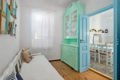 a bedroom with a blue cabinet and a table at Castello Venetsiana in Symi
