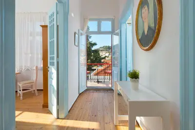a hallway with blue and white walls and a table at Castello Venetsiana in Symi