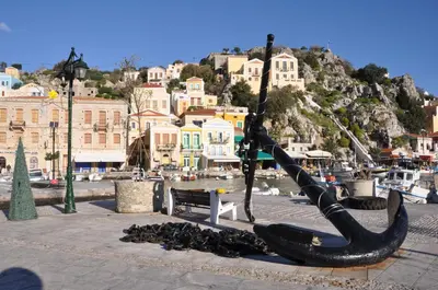 a statue of a boat on the side of a street at Annika Deluxe Apartments in Symi