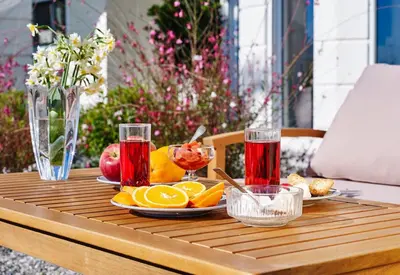 a wooden table with fruit and drinks on it at Andrealexia Sea View Villa in Kalithies