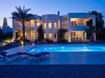 a large house with a swimming pool in front of it at Andrealexia Sea View Villa in Kalithies
