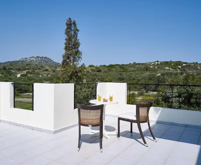 a patio with a white table and two chairs at Andrealexia Sea View Villa in Kalithies