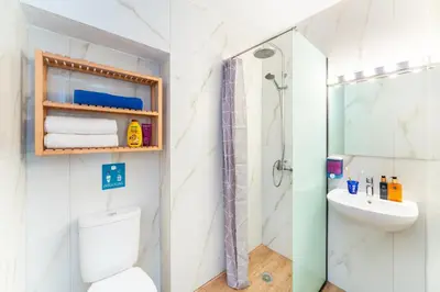 a bathroom with a shower and a toilet and a sink at STAY Rhodes HoStel & Bar in Rhodes Town