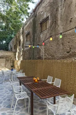 a wooden table and chairs with fruit on it at STAY Rhodes HoStel & Bar in Rhodes Town