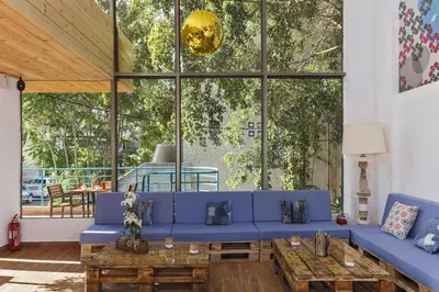 a living room with a blue couch and a table at STAY Rhodes HoStel & Bar in Rhodes Town