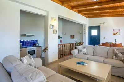 a living room with two couches and a table at Villa Seashell in Pefki Rhodes