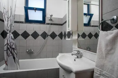 a bathroom with a sink and a bath tub at Villa Seashell in Pefki Rhodes