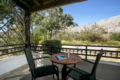 a table and two chairs on a balcony with a view at Villa Seashell in Pefki Rhodes
