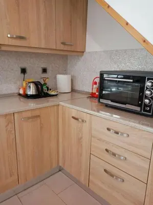 a kitchen with a counter top with a microwave at Sunnyside Apartment in Rhodes Town