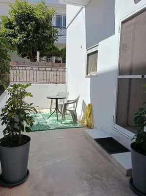 a patio with a table and chairs on a balcony at Sunnyside Apartment in Rhodes Town