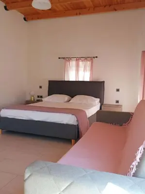 a bedroom with two beds and a window at Sunnyside Apartment in Rhodes Town