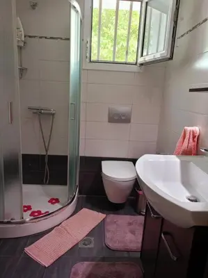 a bathroom with a shower and a sink and a toilet at Sunnyside Apartment in Rhodes Town