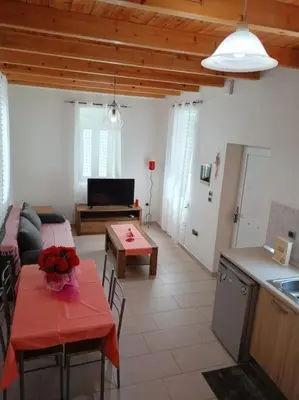 a kitchen and a living room with a table and a couch at Sunnyside Apartment in Rhodes Town