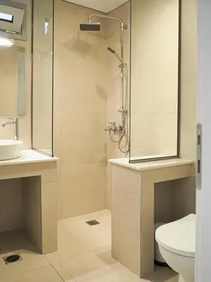 a bathroom with a shower and a toilet and a sink at Trinity Urban Residences Plumeria in Rhodes Town