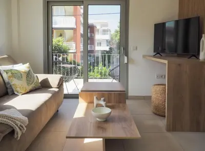 a living room with a couch and a coffee table at Trinity Urban Residences Plumeria in Rhodes Town